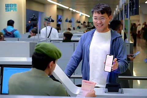 Holders of recently launched transit visas arrive at Saudi airport. 