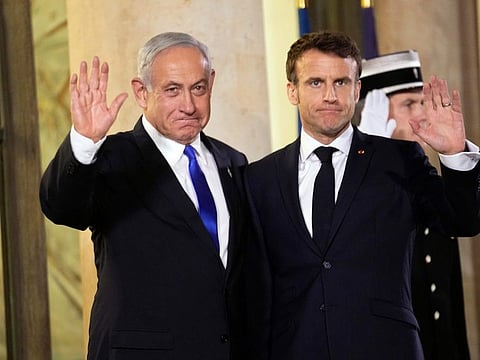 French president Emmanuel Macron, right, welcomes Israeli Prime Minister Benjamin Netanyahu prior to their meeting at the Elysee Palace, in Paris, on Feb. 2.