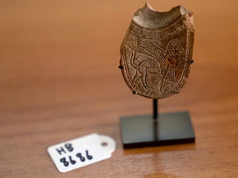 A 2,700-year-old ivory incense spoon plundered from a site in the West Bank — seized in late 2021 by the Manhattan District Attorney's office as part of a plea deal with billionaire hedge fund manager Michael Steinhardt, displayed at the Palestinian Ministry of Tourism and Antiquities in the West Bank city of Bethlehem, on January 19, 2023.  