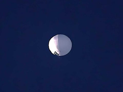 A high altitude balloon floats over Billings, Mont., on Wednesday, Feb. 1, 2023. The huge, high-altitude Chinese balloon sailed across the U.S. on Friday, drawing severe Pentagon accusations of spying and sending  excited or alarmed Americans outside with binoculars. 