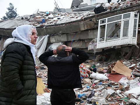 People search for survivors under the rubble following an earthquake in Diyarbakir, Turkey.
