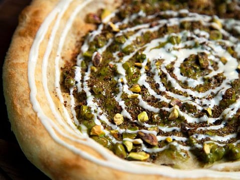 Dessert pizza with pistachio paste and white chocolate