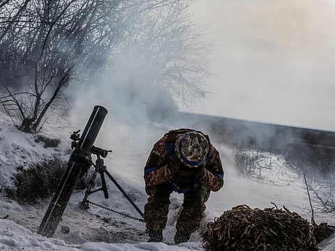 A Ukrainian service member fires a mortar towards Russian troops in frontline near the Vuhledar town in Donetsk region, Ukraine.  