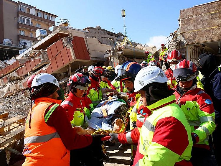 This photo taken and handed out on February 10, 2023 by the German relief organisation ISAR shows members of their rescue teams saving 40-year-old Zeynep Kahraman from the rubble of a collapsed building in Kirikhan, Turkey, more than 100 hours after an earthquake hit Turkey and Syria. 