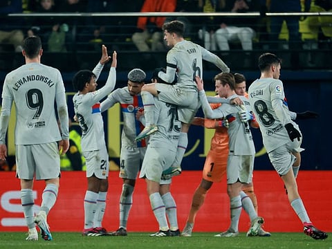 Barcelona's players celebrate victory at the end of the Spanish League match against Villarreal CF at La Ceramica stadium in Vila-real.