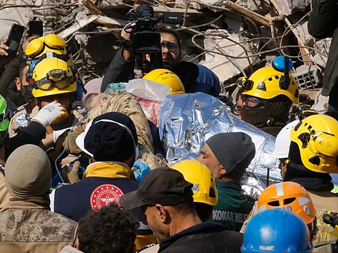 Rescuers carry Saadet Sendag, a Turkish woman who was rescued after 177 hours, as the search for survivors continues, in the aftermath of a deadly earthquake in Hatay, Turkey February 13, 2023.