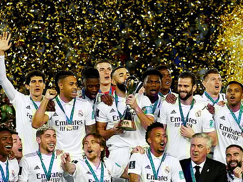 Real Madrid's Karim Benzema kisses the trophy and celebrates with teammates and coach Carlo Ancelotti after winning the FIFA Club World Cup final
