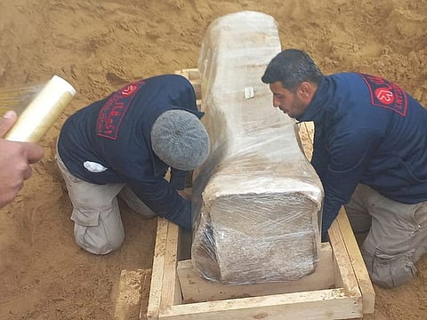 A team of archeological experts and workers, preserve a newly-discovered Roman coffin in a wooden box at the site of a 2000-year-old Roman cemetery in northern Gaza Strip February 14, 2023. 