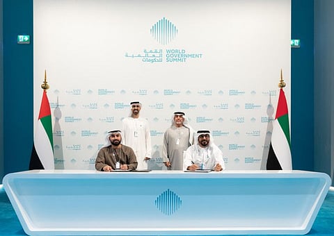 Omar Sultan Al Olama, Dr HamdanMusallam Al Mazrouei at the signing of Dh100m fund for digital education globally. Hamoud Abdullah Al Junaibi and Dr Waleed Al Ali signing the partnership. 