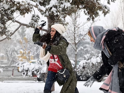 Iranian women toss snow balls at a park in the capital Tehran, on February 12, 2023.  Coverage in foreign media of the demonstrations - which Iranian authorities have generally labelled “riots” - helped “create an atmosphere of Iranophobia”, deputy tourism minister Maryam Jalali told AFP.