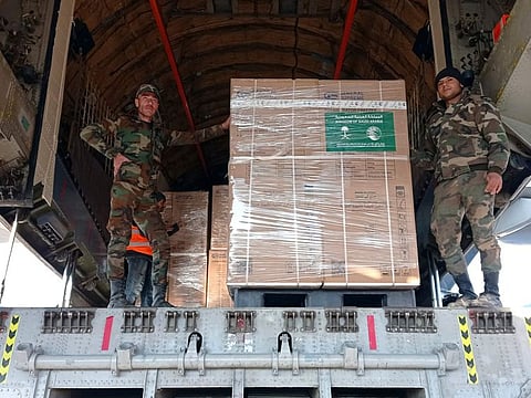 Syrian soldiers unload humanitarian aid sent from Saudi Arabia for Syria following a devastating earthquake, at the airport in Aleppo, Syria, on February 14, 2023. 