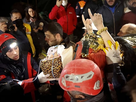 Rescuers carry Fatima, a 15 year old, after being rescued from the rubble of a collapsed building in Hatay, Turkey, on February 14, 2023. 