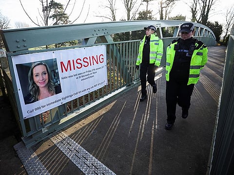Police officers walk as they continue to search River Wyre for Nicola Bulley.