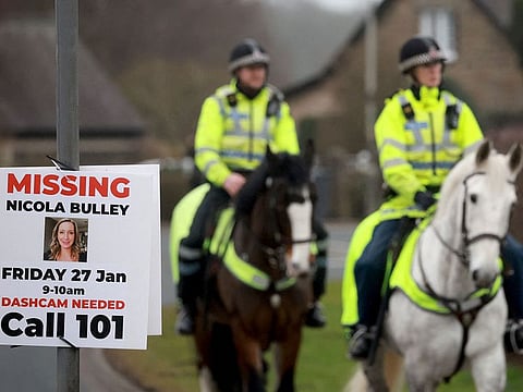 Police officers ride horses near the scene where a body, that is suspected to be missing woman Nicola Bulley, was found, in St Michael's On Wyre, Britain.