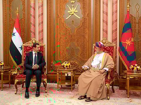In this photo released by the official Syrian state news agency SANA, Omani Sultan Haitham bin Tariq, right, receives Syrian President Bashar Assad in Muscat on February 20, 2023.  
