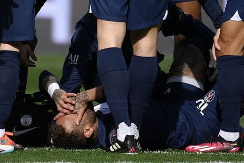 Paris Saint-Germain's Brazilian forward Neymar reacts to an injury.