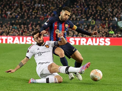 Manchester United's Bruno Fernandes (left) in action with FC Barcelona's Jordi Alba during the Europa League playoff first leg at Camp Nou, Spain. The second leg will take place tomorrow at Old Trafford with the teams tied at 2-2.