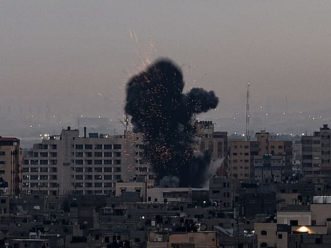  Smoke rises above buildings in Gaza City as Israel launched air strikes on the Palestinian enclave early on February 23, 2023.  