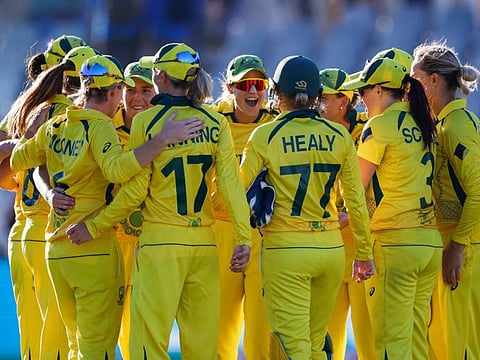 Australia players celebrate after winning the T20 women's World Cup semi-final against India at Newlands Stadium in Cape Town on Thursday.