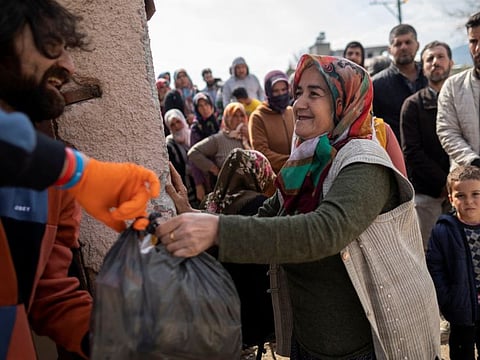 People affected by the deadly earthquake receive aid in Hatay, Turkey, February 24, 2023.  