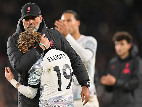 Liverpool's manager Jurgen Klopp (left) embraces midfielder Harvey Elliott after the English Premier League match against Crystal Palace at Selhurst Park in south London.