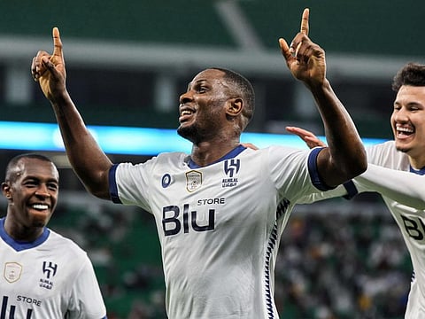 Al Hilal's Nigerian forward Odion Ighalo (centre) celebrates with teammates after scoring his fourth goal during the AFC Champions League semi-final against Al Duhail at Al Thumama Stadium in Doha.