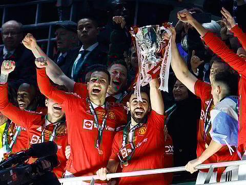 Manchester United's Bruno Fernandes lifts the League Cup trophy with teammates after his side beat Newcastle 2-0 in the final at Wembley Stadium.
