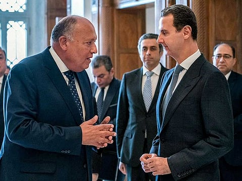 This handout picture released by the Egyptian Foreign Ministry shows Egypt's Foreign Minister Sameh Shoukry (L) meeting with Syrian President Bashar Al Assad (R) in Damascus on February 27, 2023. 