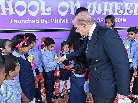 Shehbaz Sharif with students on School on Wheels buses in Islamabad on February 28, 2023.  