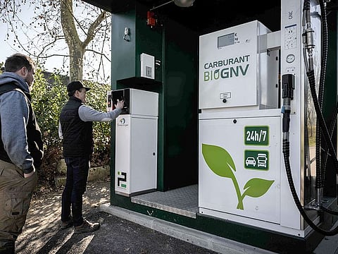 French farmer Bertrand Guerin (C) uses a biomethane refueling station on the farm of the Guerin family, which produces biomethane, also known as renewable natural gas, in Beaumontois-en-Perigord, southwestern France.
