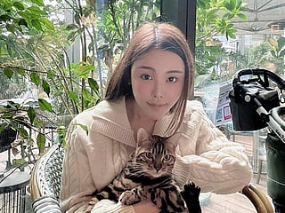 In this photo taken and provided by Pao Jo-yee, model Abby Choi, holding a cat, poses for a photo on Feb. 11, 2023, in Hong Kong. 