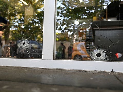 Bullet holes are pictured on a supermarket door that belongs to the family of Antonela Roccuzzo, wife of Lionel Messi, after two people on motorcycles attacked it and left a threatening message for Messi and the city mayor, Pablo Javkin, in Rosario, Santa Fe province, Argentina March 2, 2023. 