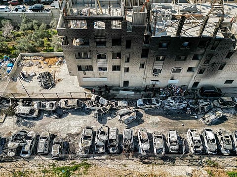This picture taken on February 27, 2023 shows an aerial view of a scrapyard where cars were torched overnight, in the Palestinian town of Huwara near Nablus in the occupied West Bank.  