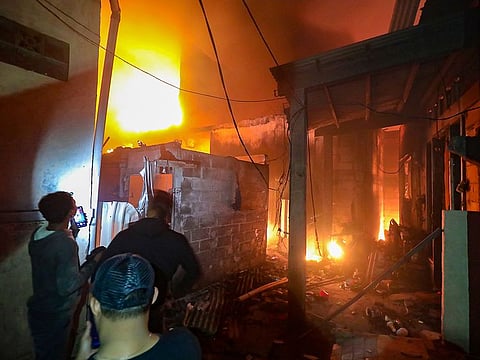 Residents try to find victims from their burned houses at a residential area located near the site of the fire of the fuel depot owned by the state-owned oil and gas company Pertamina, in Plumpang, Jakarta, on March 3, 2023.  