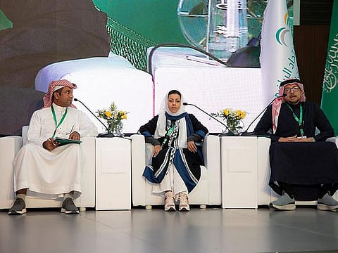 President of the Saudi Yoga Committee Nouf Al Marwaai (centre) attends a symposium in Riyadh. 