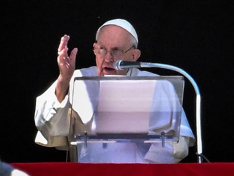 Pope Francis speaks from the window of the apostolic palace during the weekly Angelus prayer in The Vatican. 
