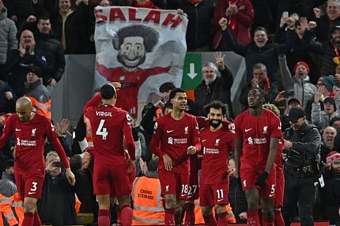 Liverpool's Egyptian striker Mohamed Salah (centre right) celebrates with teammates after scoring their fourth goal during the English Premier League match against Manchester United at Anfield in Liverpool, north west England. Liverpool won 7-0.