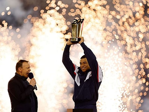 Paris St Germain's Kylian Mbappe celebrates with a trophy during the ceremony after becoming Paris St Germain's all time top goalscorer with 201 goals