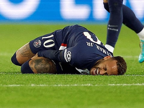 Paris St Germain's Neymar reacts after sustaining an injury.
