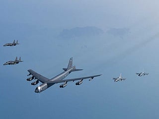In this photo provided by South Korea Defense Ministry, a US Air Force B-52H Stratofortress aircraft, centre, flies in formation with South Korea's Air Force KF-16 fighters and South Korea's Air Force F-15K fighters over the western sea of Korean peninsula during a joint air drill in South Korea, Monday, March 6, 2023. 