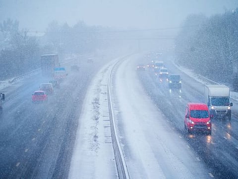 Cars driving through snow on the northbound carriageway of the M5 motorway near Taunton, which has been reduced to two lanes due to snow, as parts of the UK wake up to snow and a yellow weather warning, Wednesday March 8, 2023.