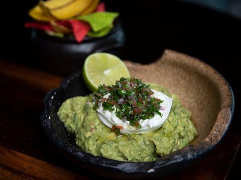 Chips and guacamole with fresh tabbouleh and burrata cheese