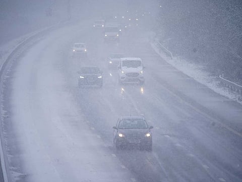 Cars driving through snow on the northbound carriageway of the M5 motorway near Taunton, which has been reduced to two lanes due to snow, as parts of the UK wake up to snow and a yellow weather warning, Wednesday March 8, 2023.