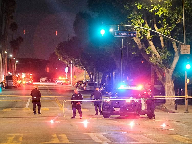Police officers stand guard near a crime scene