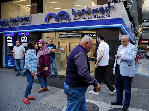 Lebanese clients wait outside a private bank. The banks first closed their doors on February 7 to protest against snowballing legal action they have been facing since Lebanon’s economy began to unravel more than three years ago.