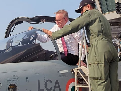 Australian Prime Minister Anthony Albanese climbs inside the cockpit of LCA onboard INS Vikrant, in Mumbai on Thursday, March 9, 2023.