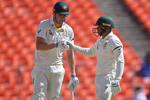 Australia's Usman Khawaja (right) and Cameron Green wear black armbads during their partnership on Day two of the fourth Test in Ahmedabad on Friday.