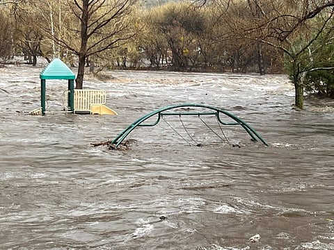 Playground equipments are submerged in the overflowing Kern River in Kernville, California, on March 10, 2023 in this image obtained from a social media.  