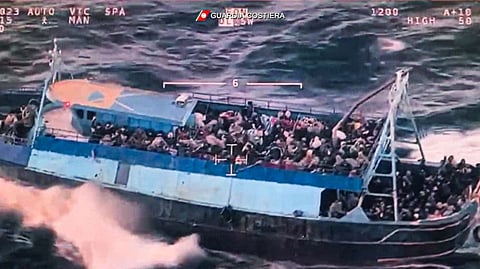 This photo grabbed from an aerial video made available by the Italian Coast Guards on March 11, 2023 shows a boat overloaded with migrants during a Coast Guards rescue operation on March 10, 2023 off the coast of Calabria, southern Italy.  