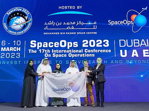 MBRSC hands over the SpaceOps flag to Gerard Gallet and Hubert Fraysse from CNES, the host of the next SpaceOps Workshop, during the closing ceremony in Dubai on Friday